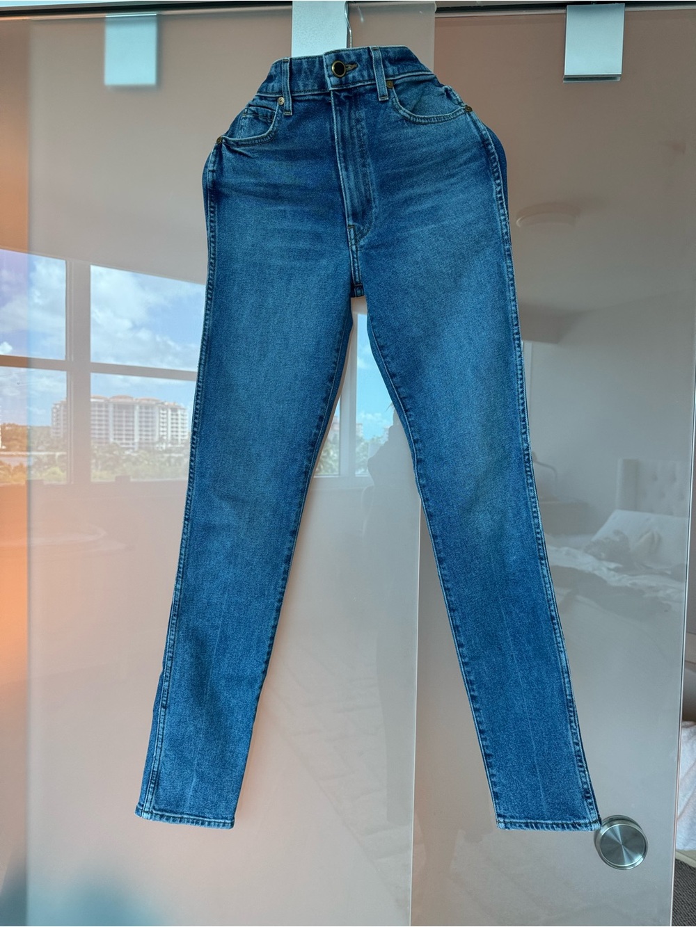 KHAITE High-Rise Slim Straight Jeans in Deep Blue Wash